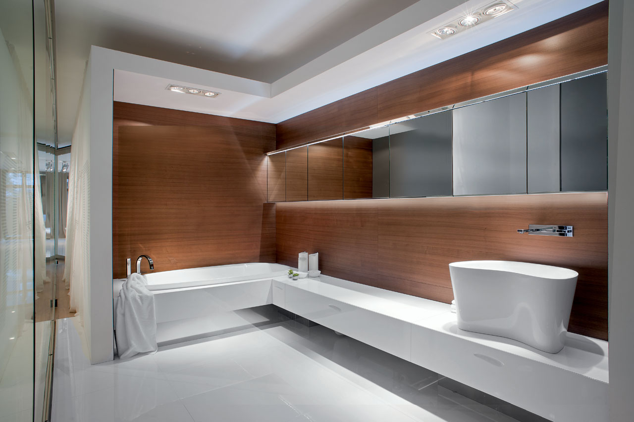 Seamless solid surface bathroom with walnut cladding